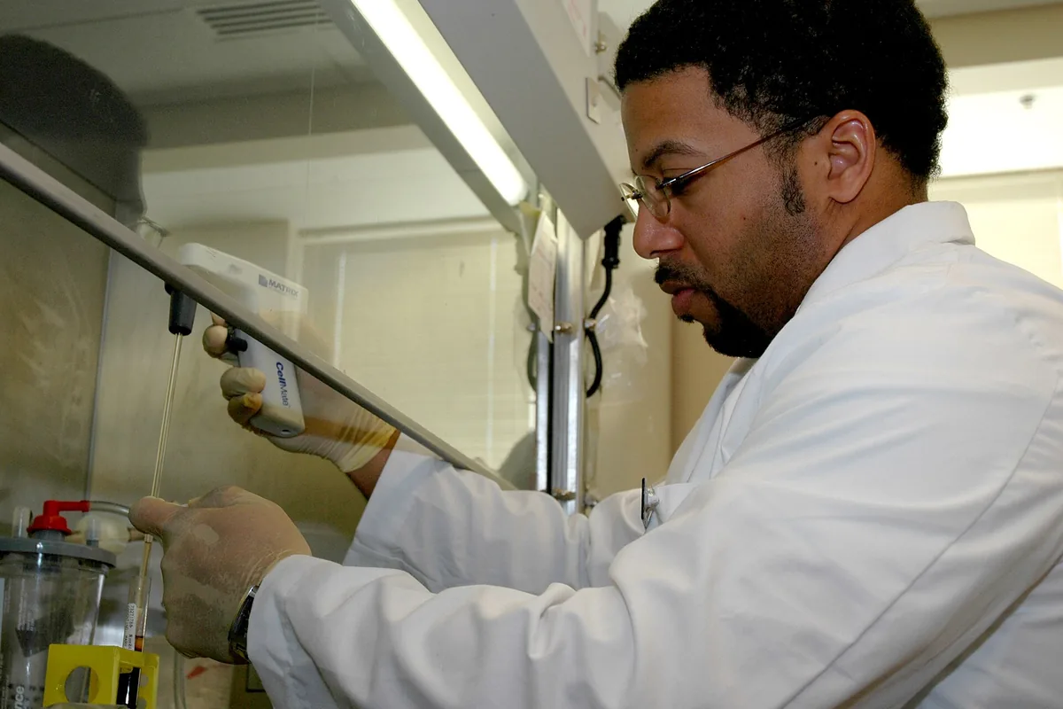 Laboratory technologist pipetting samples in a clinical lab